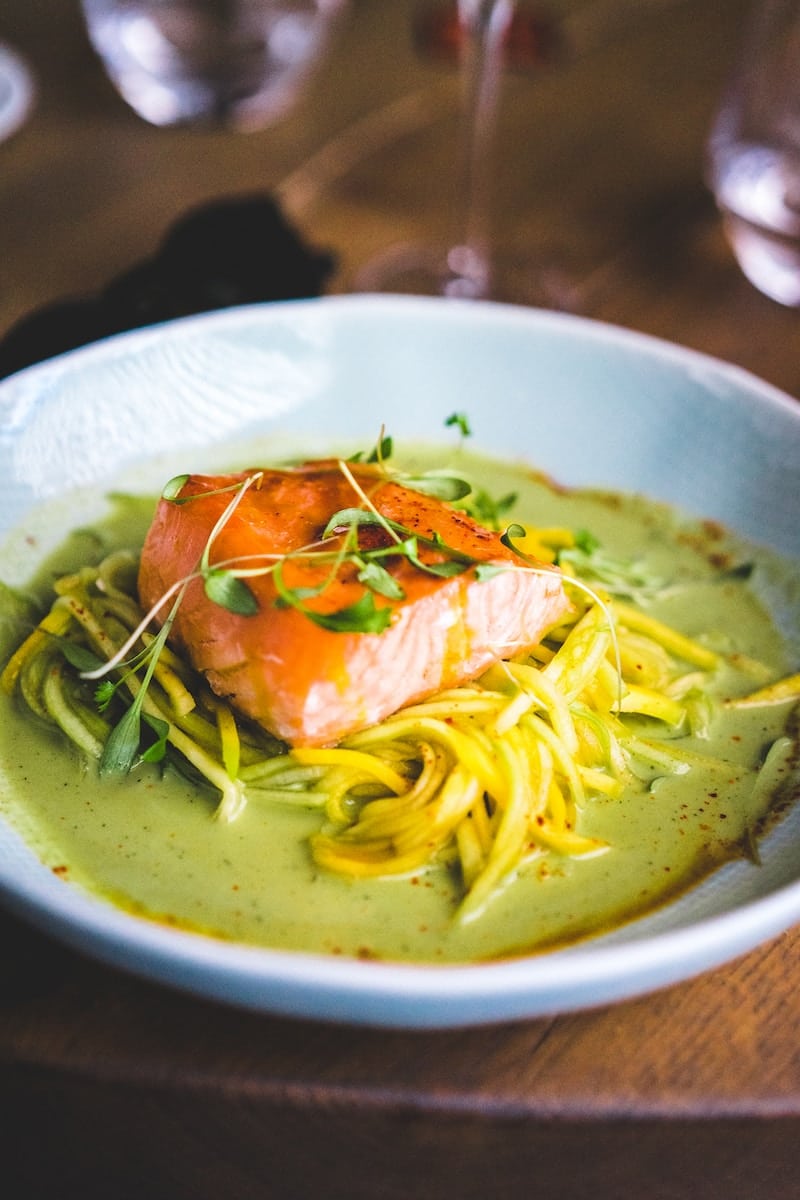 pasta with green leaf on white ceramic plate